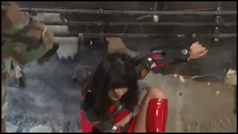 Dark-Haired Beauty in Red and Black Costume