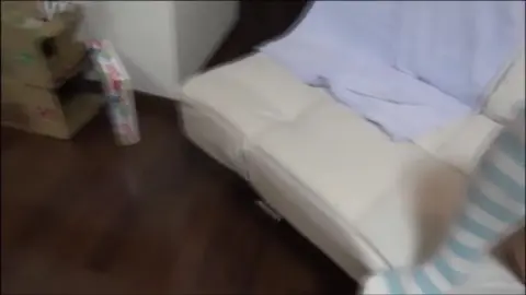 Asian Couple Intimate Moments on White Couch