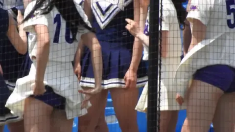 Asian Cheerleaders in Stadium