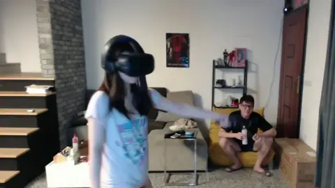 Asian Couple Wearing VR Headset in Living Room
