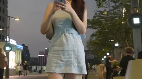 Asian Girl on City Street at Dusk