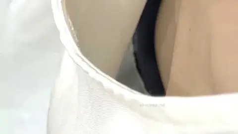 Slim Caucasian Woman Undressing in Intimate Setting