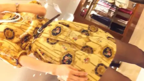 Asian Girl Tries On Dresses in Clothing Store