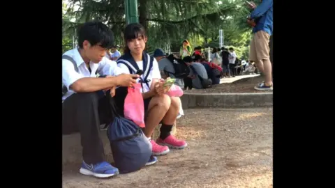 Asian Teens in School Uniforms Outdoor Encounter