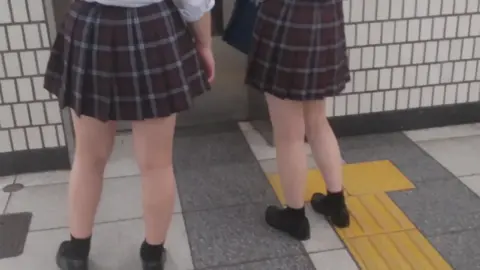 Asian Schoolgirls in Subway Station
