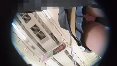 Asian teen in black skirt and stockings on train