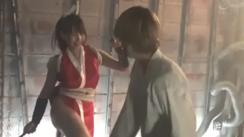 Asian Girl in Red and White Costume in Industrial Setting