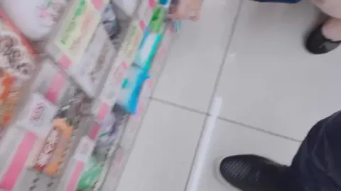Asian Couple Intimate Moment in Supermarket