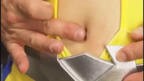 Asian woman in costume undressed by man