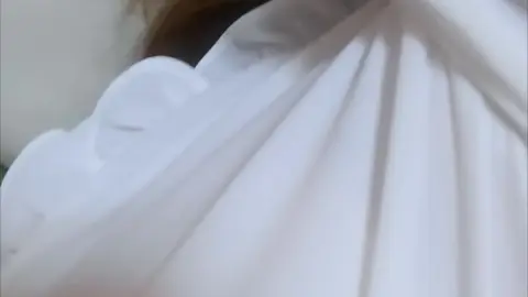 Asian Teen Lounges on Sofa in Bedroom