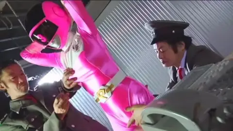 Asian Schoolgirl in Pink Costume and Uniform