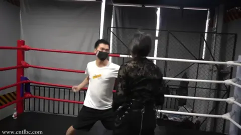 Asian Couple in Boxing Ring Encounter