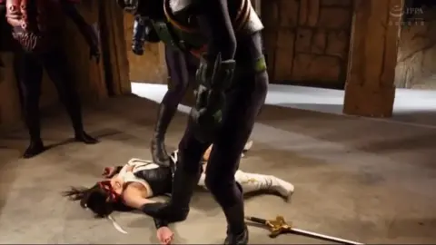 Asian Women in Costume Engage in Erotic Sword Fight