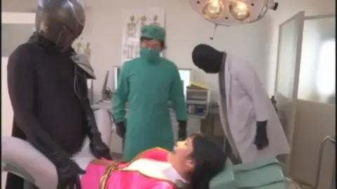 Asian Women in Pink Costumes Examined in Medical Lab