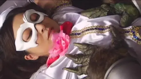 Asian Girl in White Costume Performs Erotic Acts