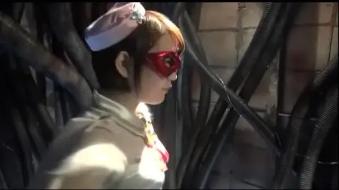 Asian Cosplay Fight Scene with Red Mask