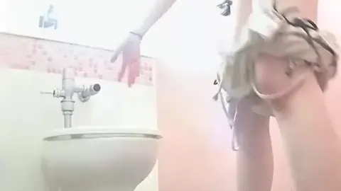 Asian girl urinating in bathroom