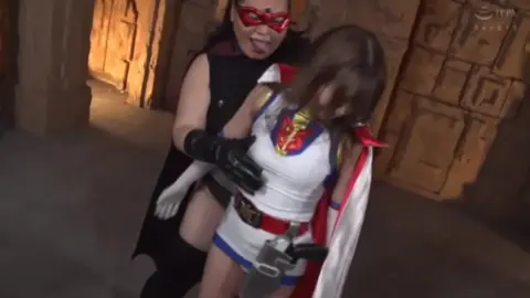 Asian Couple in Cape and Mask Embrace