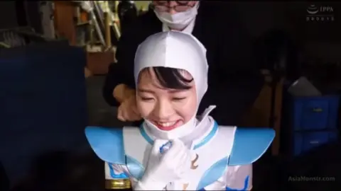 Asian cosplayer in explicit scenes backstage and outdoors