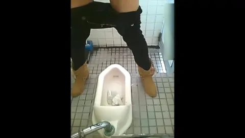 Asian Couple Urinating in Bathroom