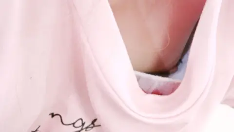 Blonde Asian Woman Exposing Cleavage