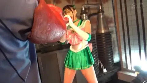 Asian woman in green choker fights off armored attacker