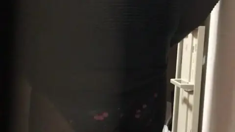 Brunette in Lingerie in Dimly Lit Closet