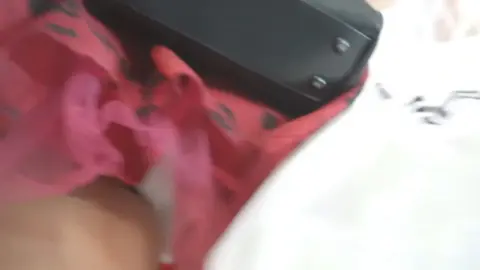 Asian teen in red dress poses