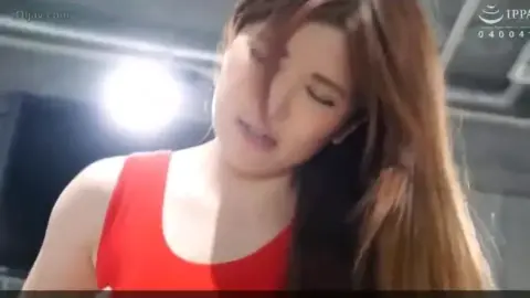 Asian Couple Engaging in Intimate Acts Indoors