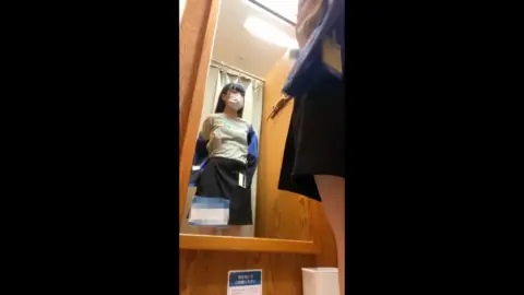 Asian Teen Tries On Clothes in Fitting Room