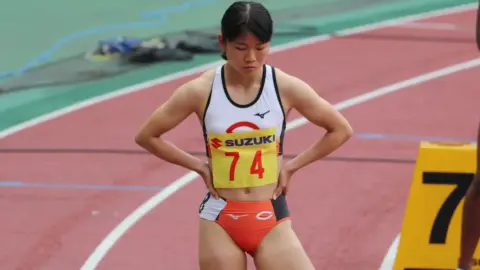 Asian Athlete in Orange Athletic Wear