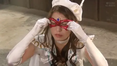 Asian Performer in Red Mask and White Lingerie