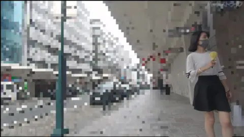 Asian Girl in Black Skirt on City Street