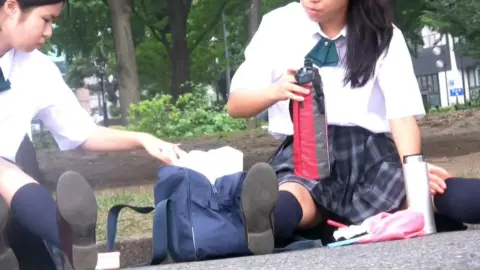 Asian Schoolgirls in Uniform Funneling in Park