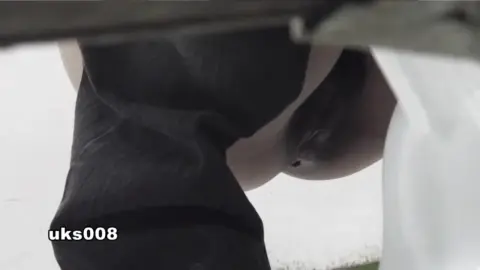 Asian Woman Urinating in Bathroom