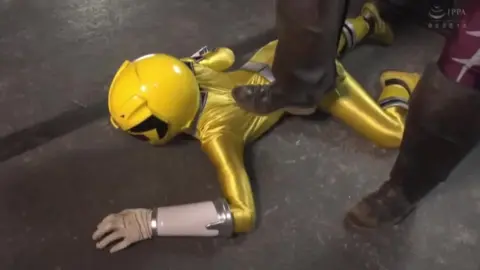 Woman Lying on Ground Being Lifted