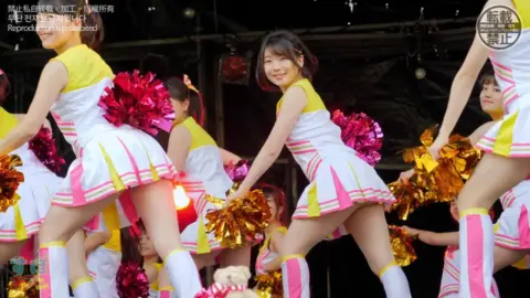 Asian Cheerleaders Dancing in Uniform